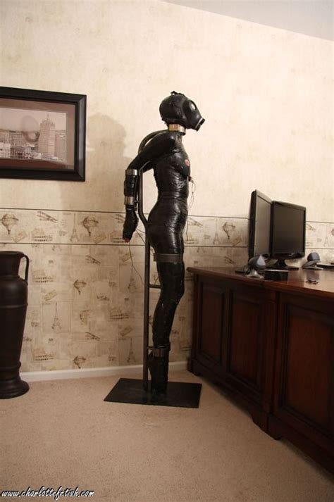 Metal bondage, dronification, tied up, latex rubber parody.
